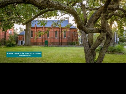 exterior photo of Chapel wall framed by the branches of tree that used to grow on lawn