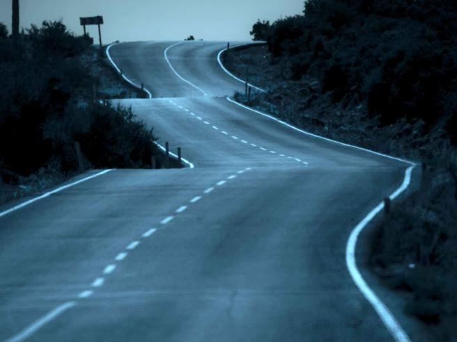 road on a wintry night winding through the hills 