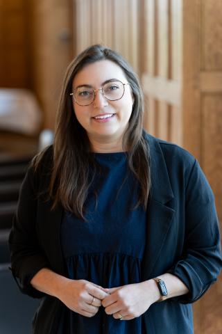Juliana Phail in Great Hall against wood panelling (2025)